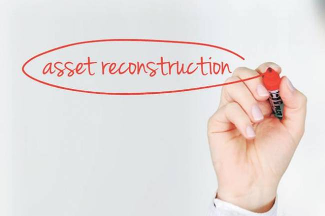 How do asset reconstruction companies work in relation to banks?